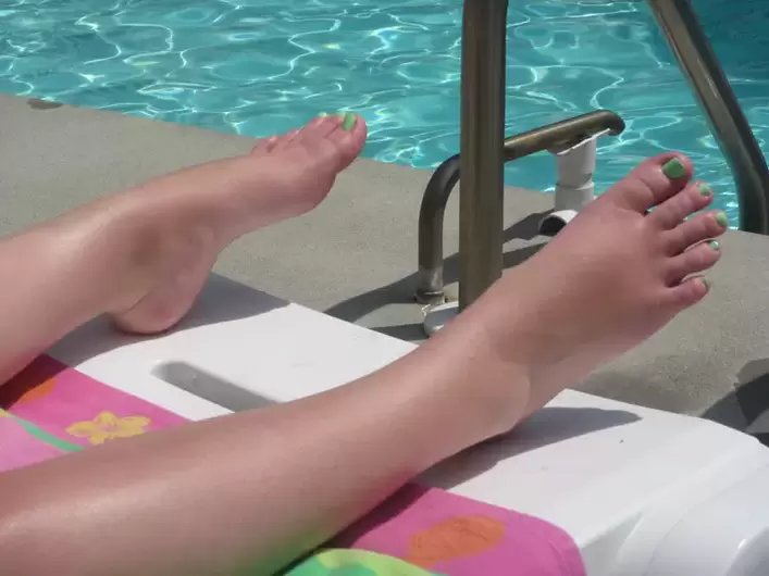 Feet without fungus by the pool